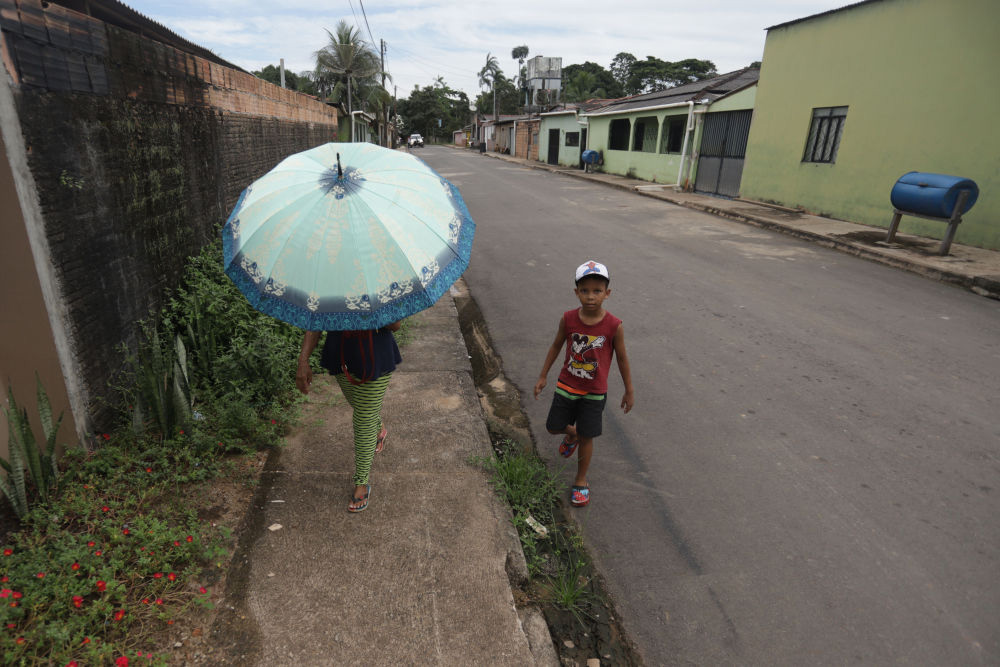 5月19日，在巴西帕拉州巴西诺沃，人们在一条铺设好的道路上行走。